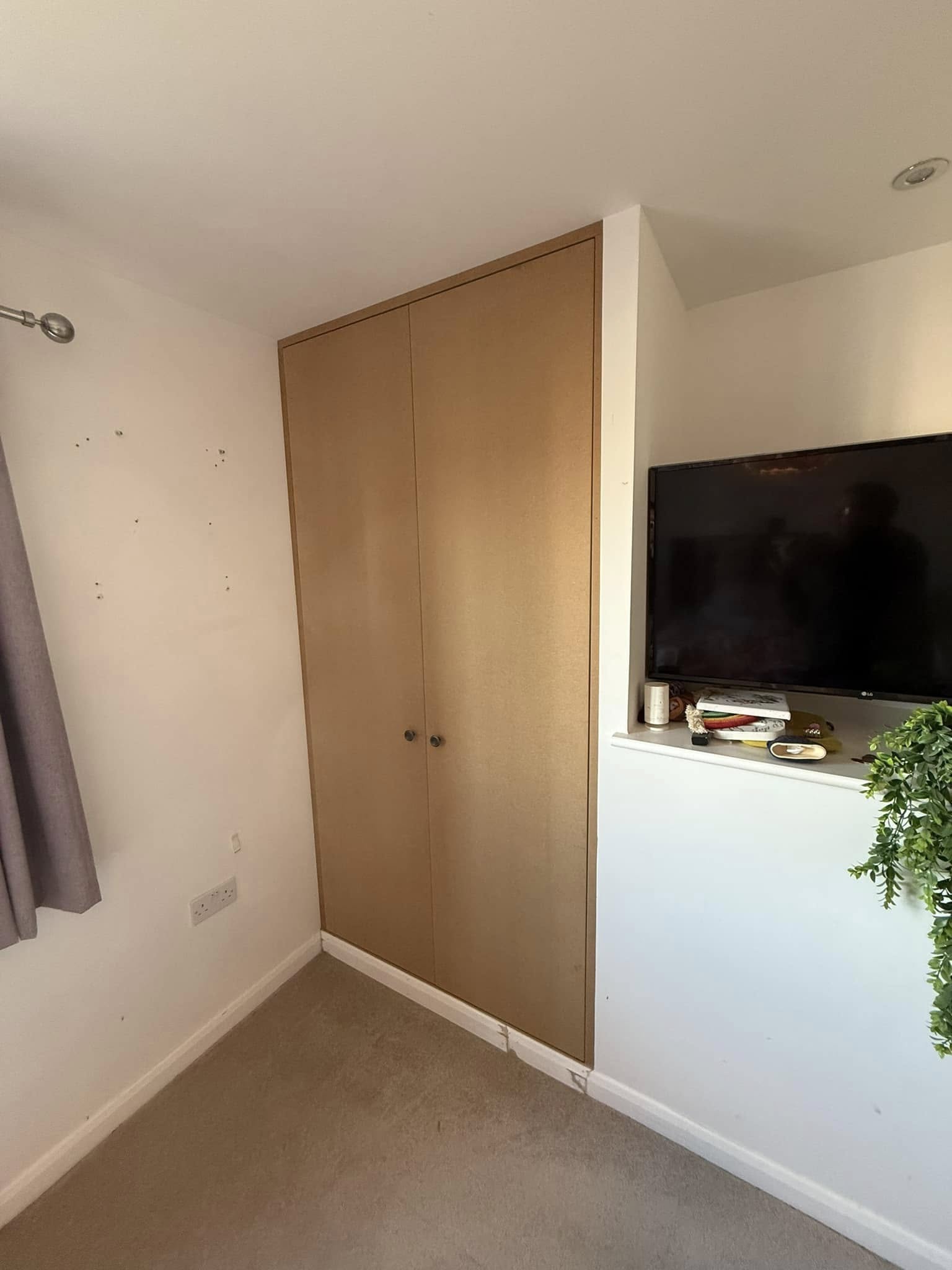 Tailored bedroom wardrobe in Edinburgh with organized shelves and hanging space