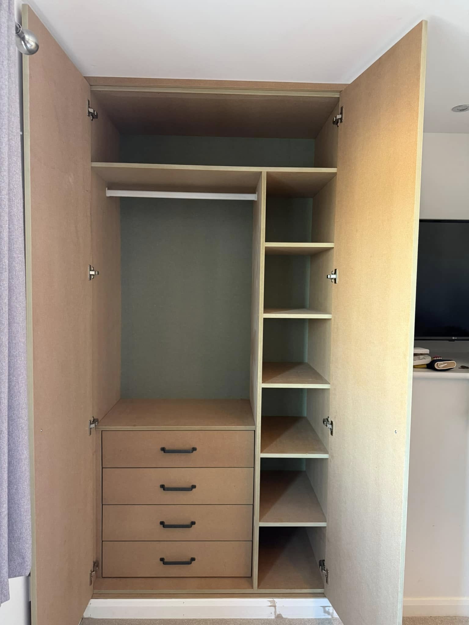 Tailored bedroom wardrobe in Edinburgh with organized shelves and hanging space