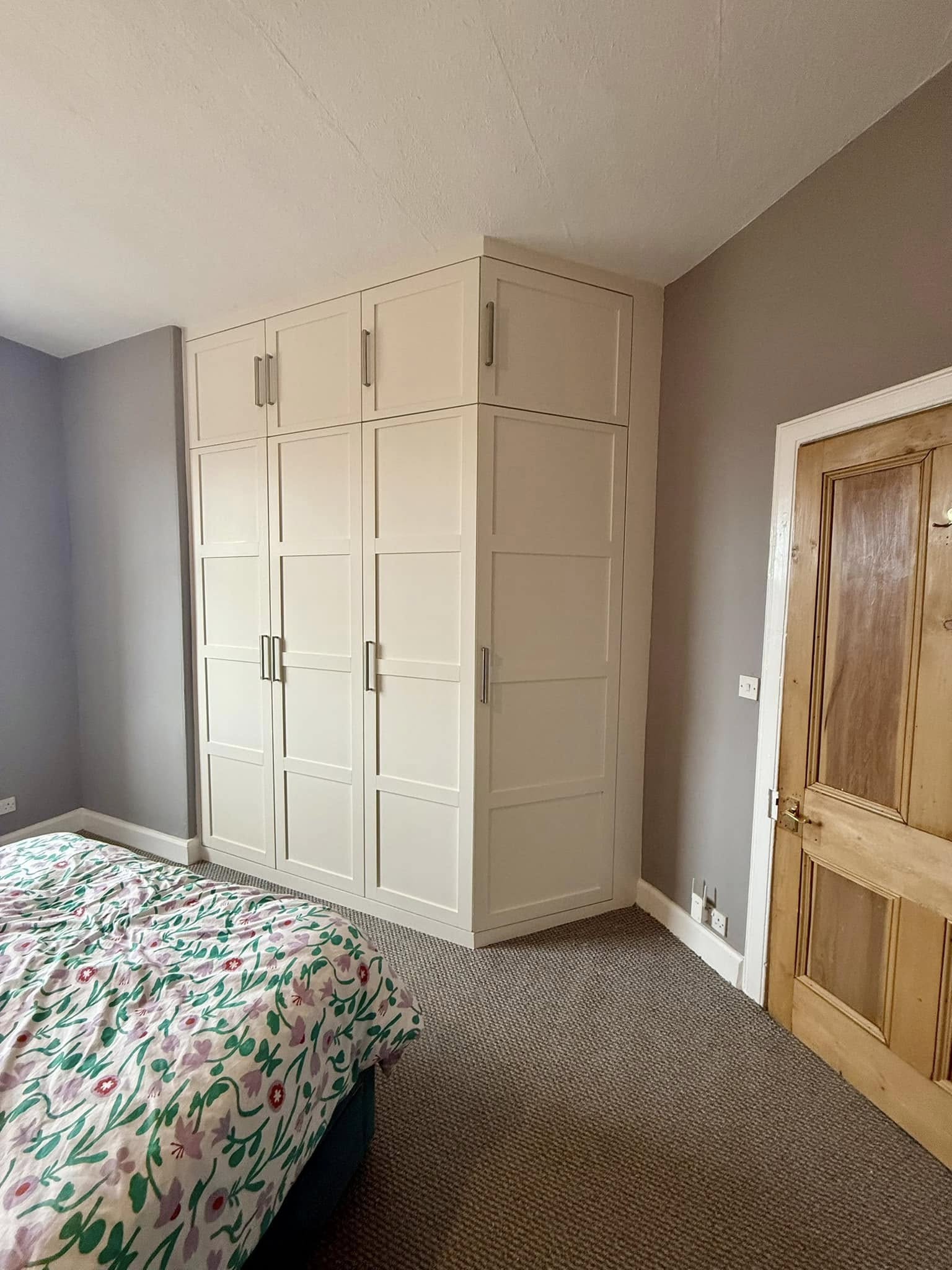 Bespoke wardrobe in Edinburgh bedroom with custom shelving and sliding doors by SJC Joinery (Scot) Ltd lighting