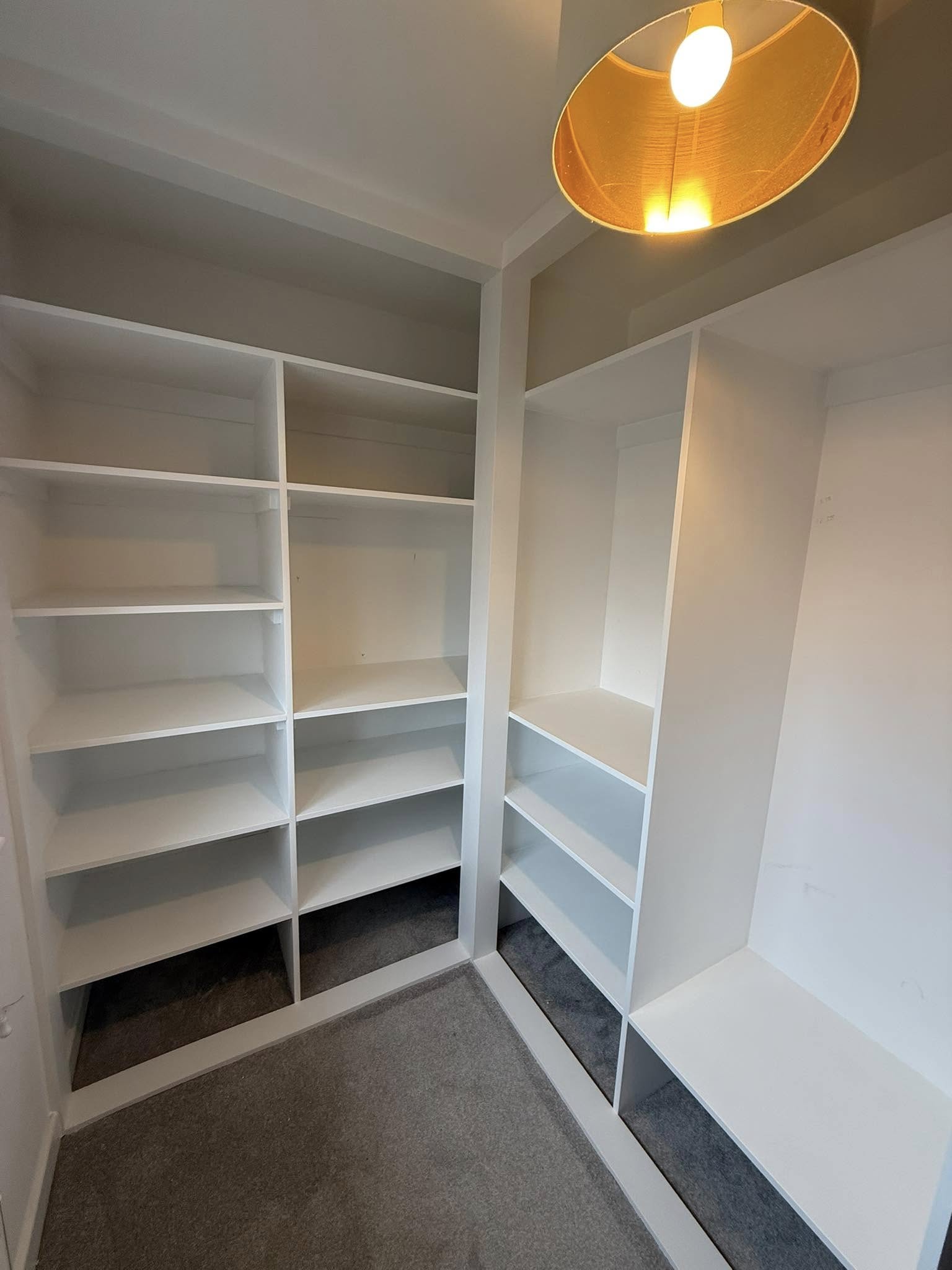Bespoke wardrobe in Edinburgh bedroom with custom shelving and sliding doors by SJC Joinery (Scot) Ltd
