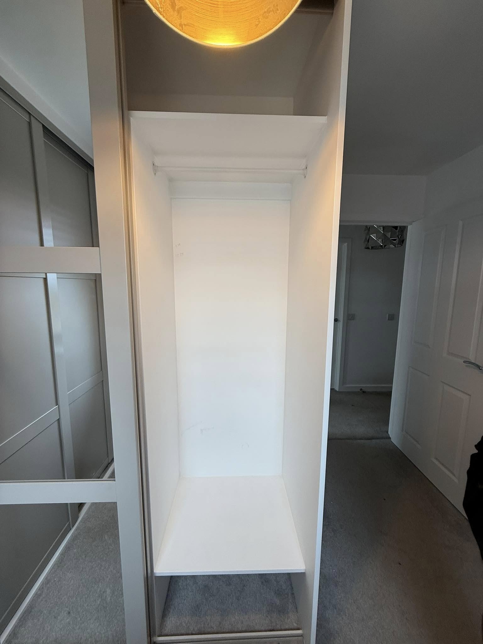 Tailored bedroom wardrobe in Edinburgh with organized shelves and hanging space