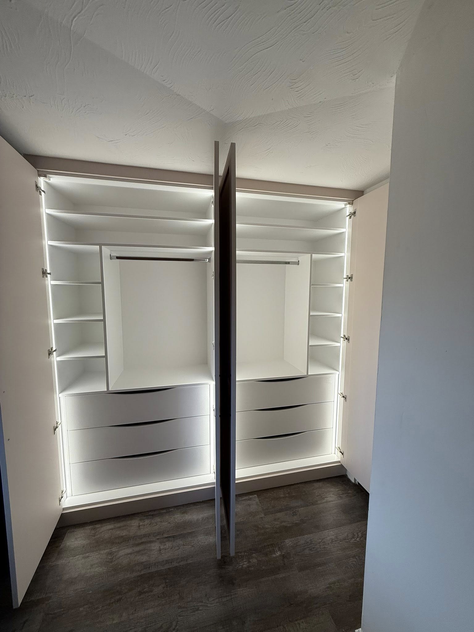 Bespoke wardrobe in Edinburgh bedroom with custom shelving and sliding doors by SJC Joinery (Scot) Ltd lighting