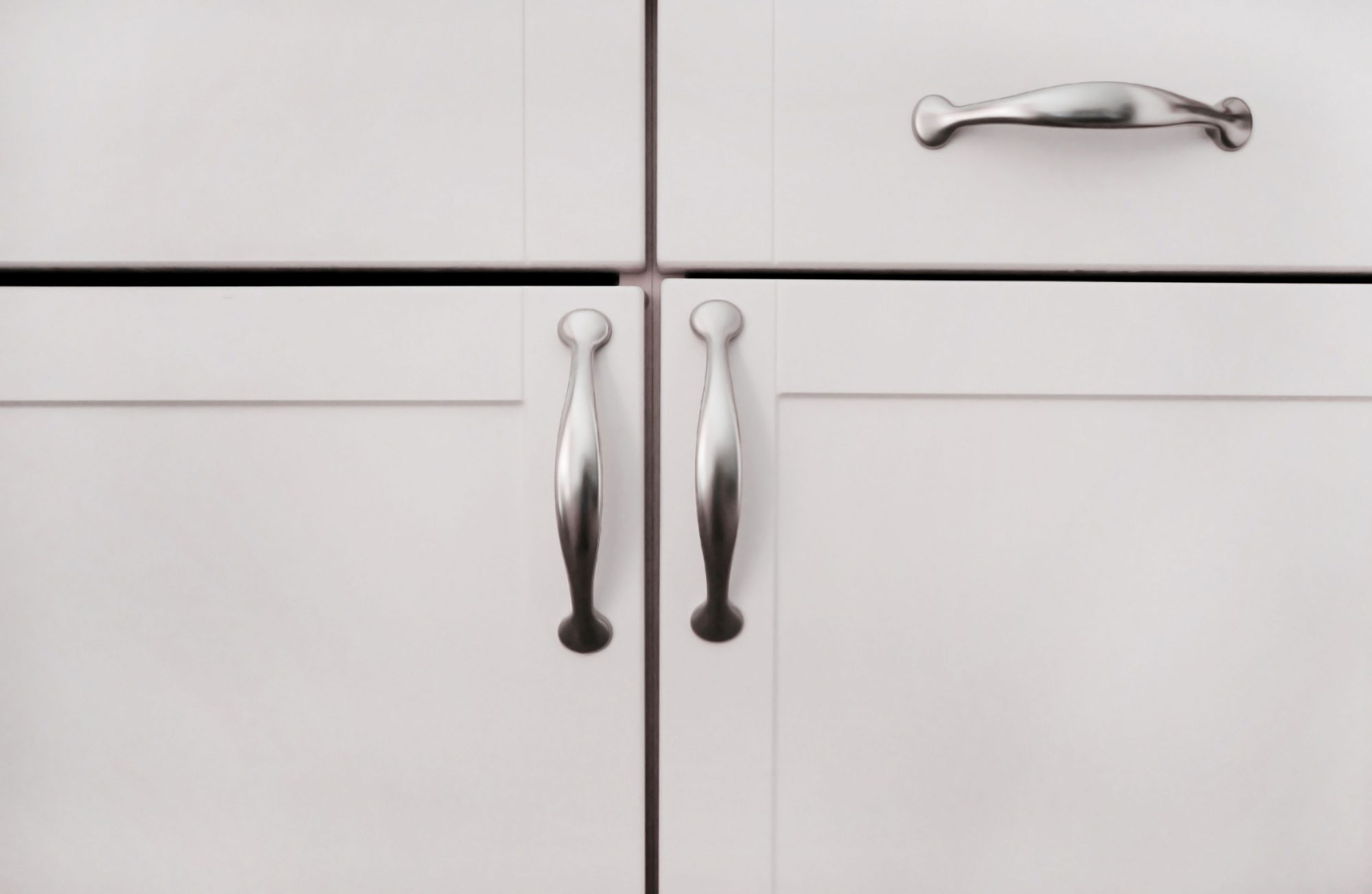 White Cabinets. White cabinet doors and a drawer with silver handles.